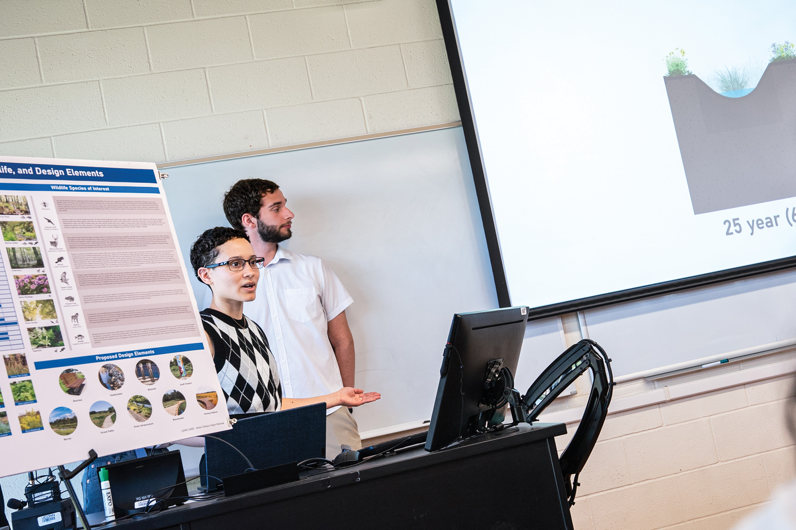 students presenting landscape architecture plans in front of a class