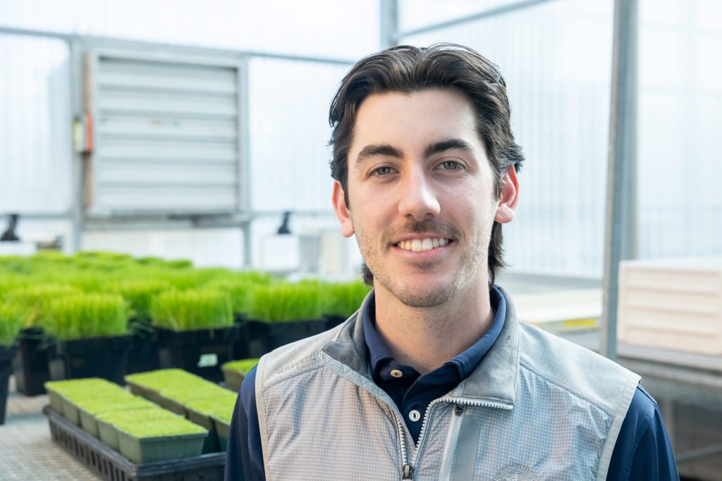 Matt Antunes posing in a greenhouse