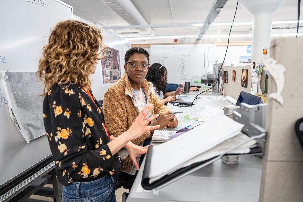 Student and a professor having a discussion in the LA Studio