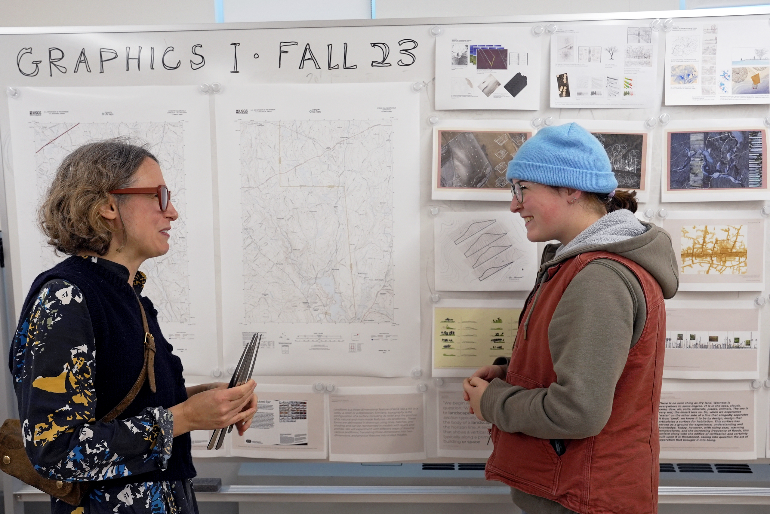 student and professor in front of landscape architecture plans