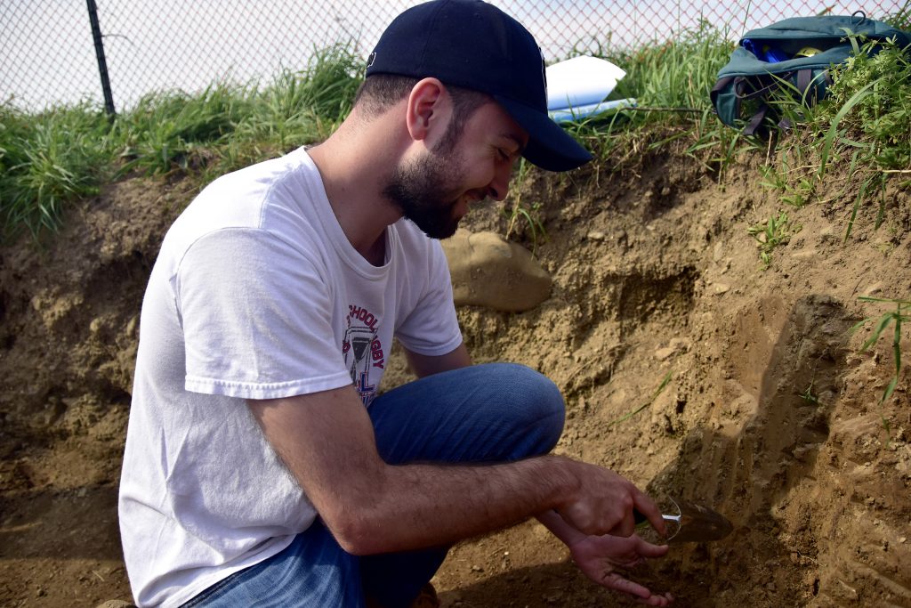 student digging into soil