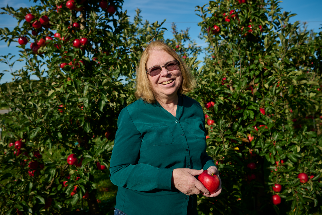 Susan in an apple orchard