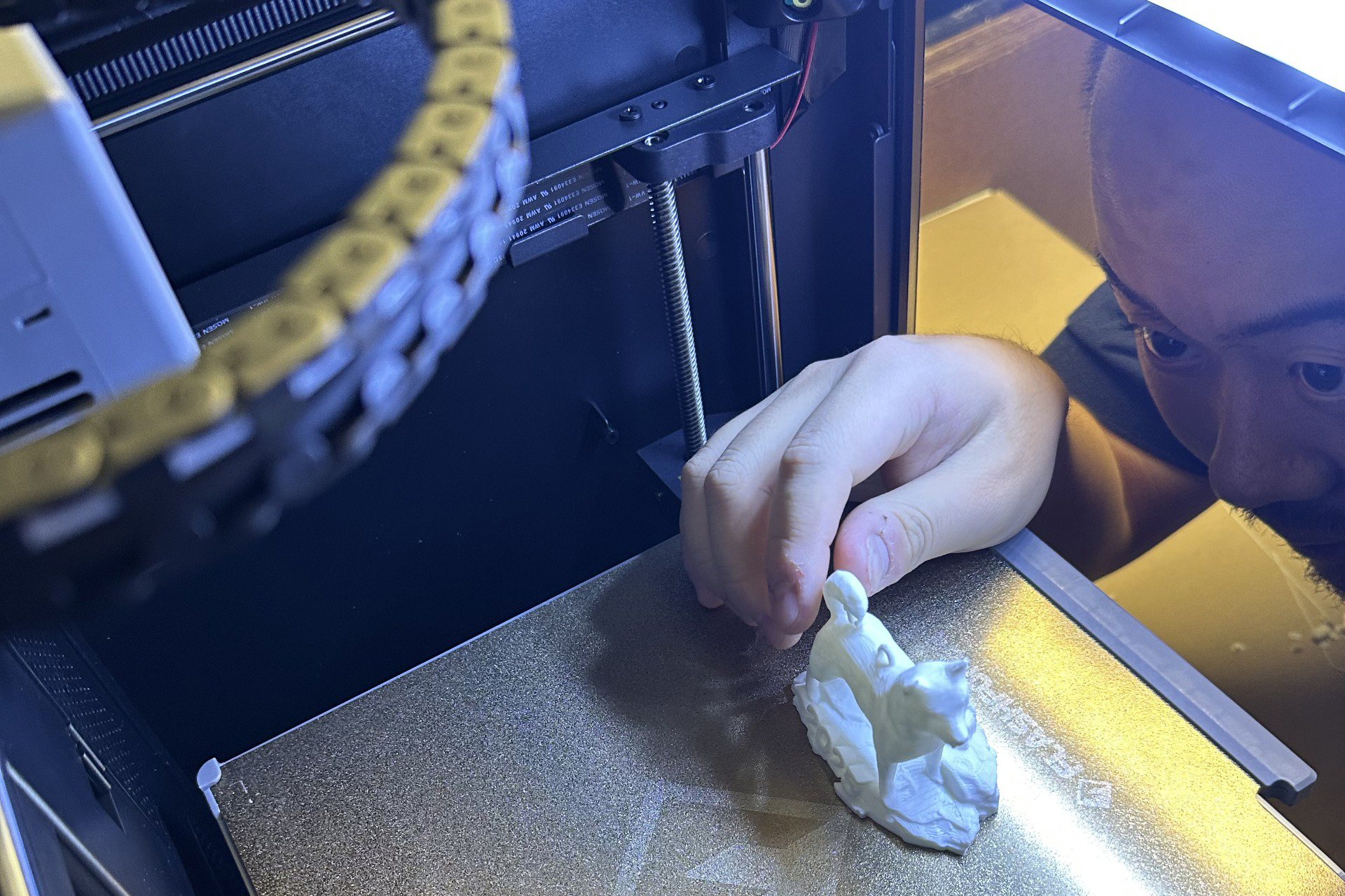 student pulling a 3D print of the Jonathan statue