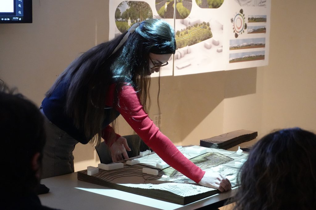 Student building an architectural model